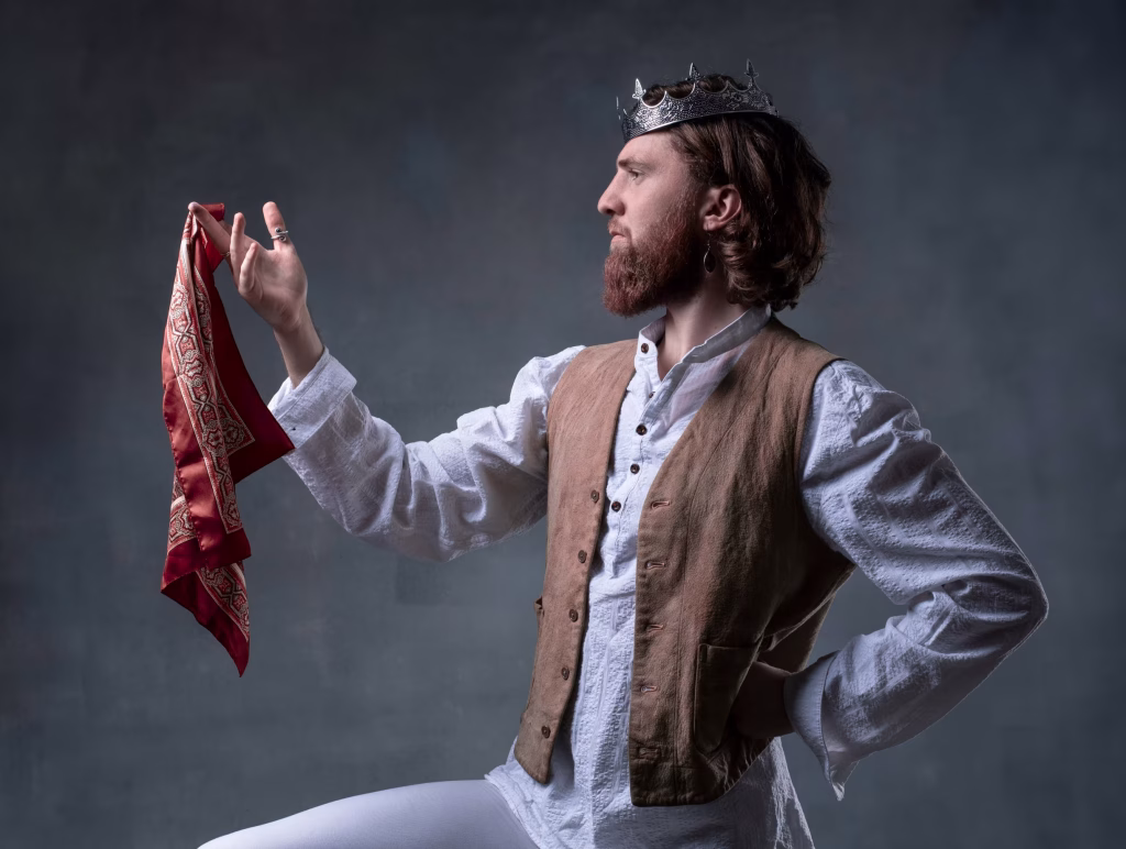 George dressed as a flamboyant Thespian, with a crown and handkerchief (and a waistcoat).